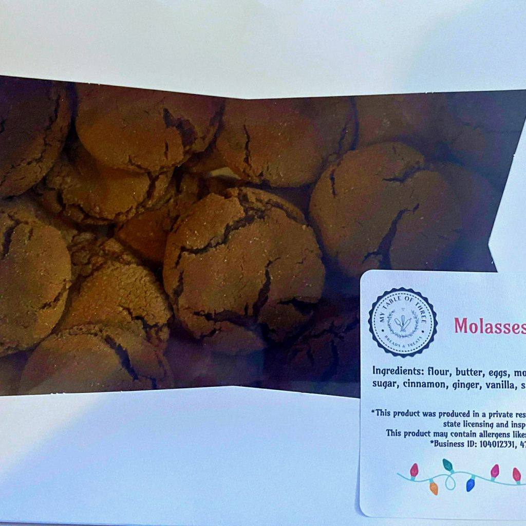 Two dozen chewy Molasses Cookies in a White Bakery Box with a label.